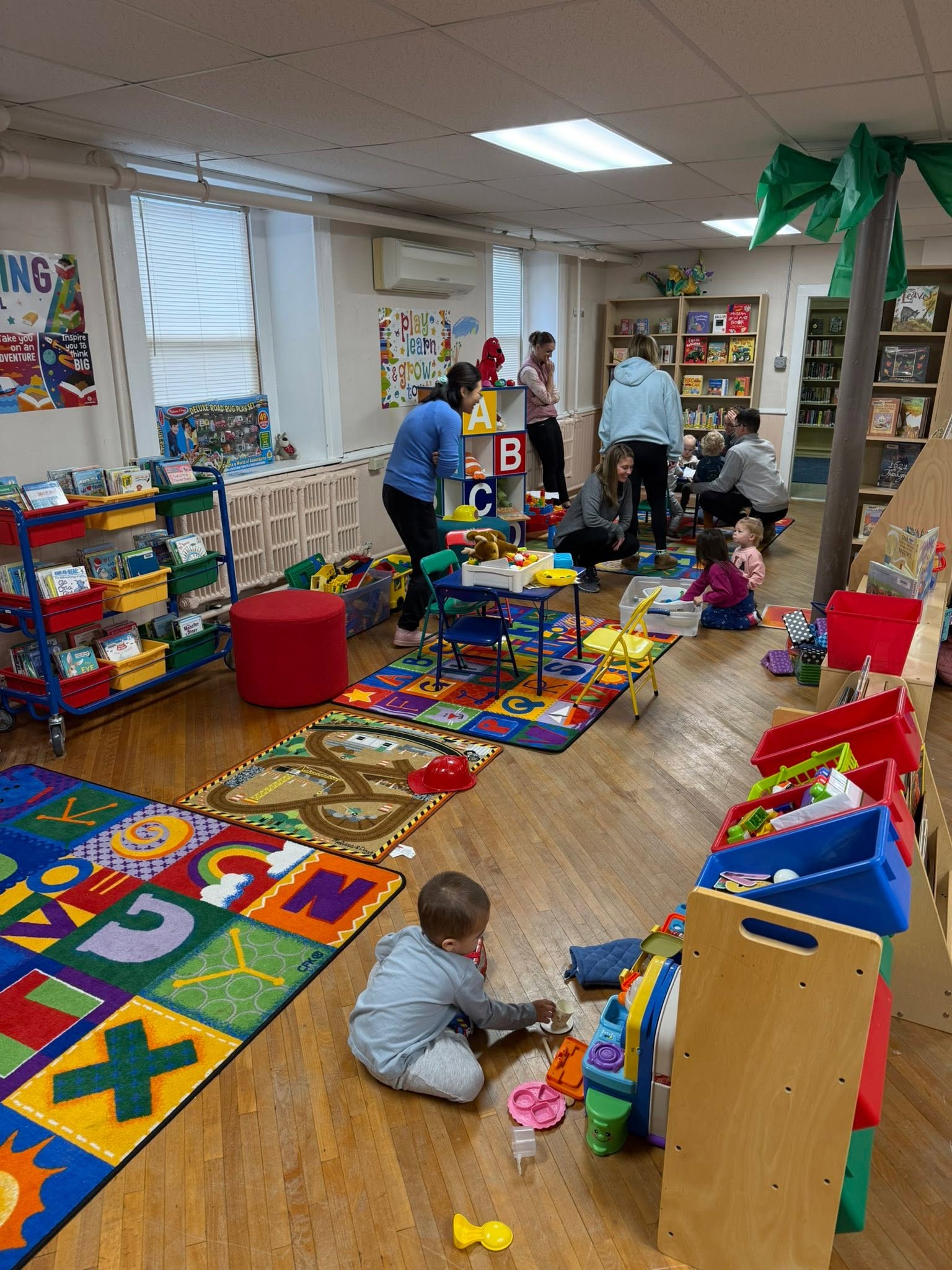 Children and caregivers participating in library storytime